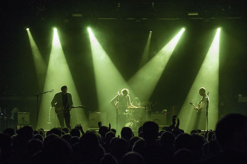 Real Estate performing live under dramatic stage lights