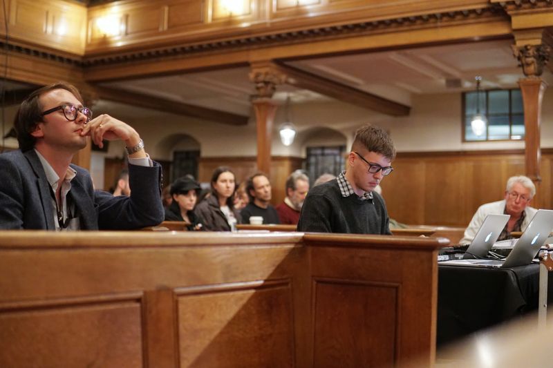 Francesco performing in a church
surrounded by a pensive audience
